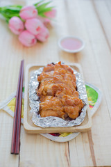 Baked chicken breast on wood table.