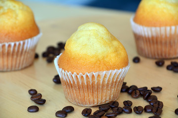 Homemade Muffins With Coffee Beans On A Wooden Table