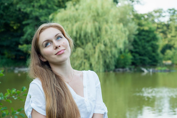 Portrait of a young woman near the lake