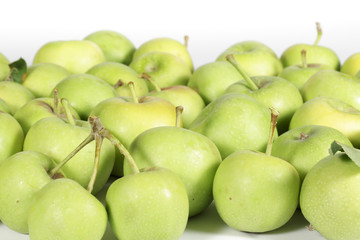 Small green apples on white