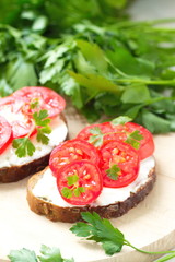Sandwiches with creamy cheese and fresh tomatoes