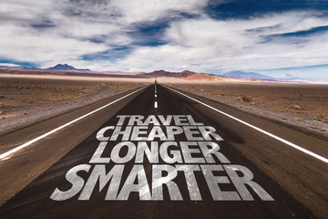 Travel Cheaper Longer Smarter written on desert road