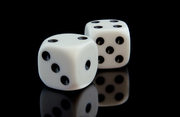 Two game cubes on the black reflecting surface.