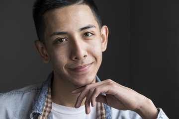 Studio portrait of a young man smiling, close up
