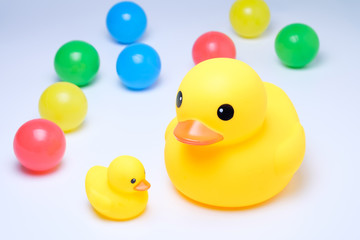 yellow rubber duck with colorful ball