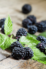 Fresh blackberries with leaves on the old wooden background, sel