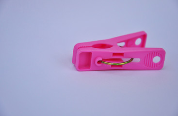 A pink clothespin on white background