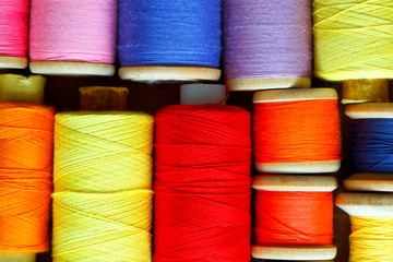 Coils with color threads. Industrial background.