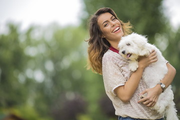 Young woman with a maltese dog