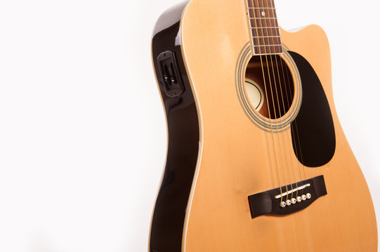 Electric acoustic yellow guitar close up isolated on white background
