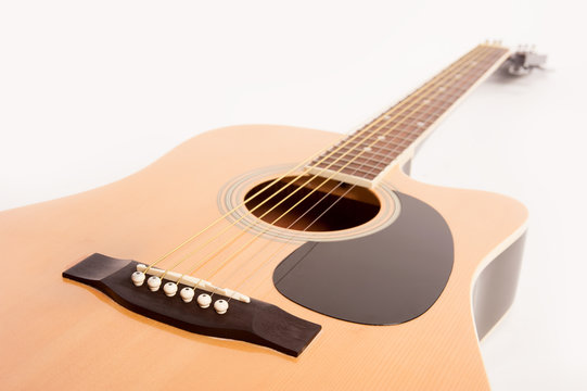Electric acoustic yellow guitar close up isolated on white background
