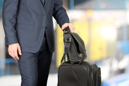 young businessman  in  a modern  stylish suit with  luggage in