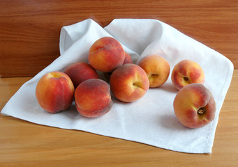 Fototapeta na wymiar Ripe peaches on a white napkin