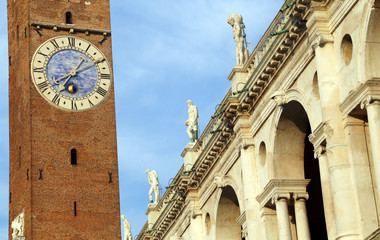 Fototapeta na wymiar Clock Tower in the Main Square Called Piazza dei Signori and Bas