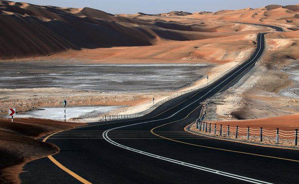 Winding road and sand dunes in Liwa, United Arab Emirates