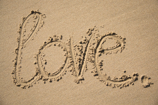 The word love written in the sand on a beach in Mozambique
