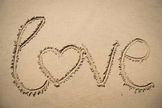 The word love written in the sand on a beach in Mozambique
