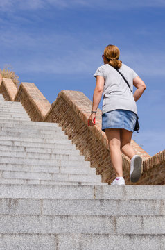 Woman Wearing Miniskirt Walking Up The Stairs