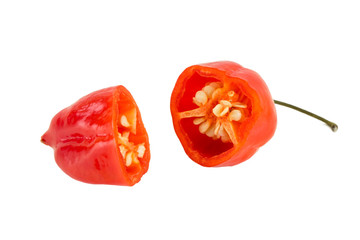 Close-up of a ripe red habanero chili cut in half, isolated on white background.