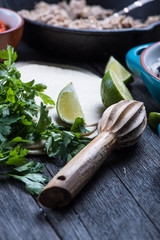 Making traditional mexican burritos with pulled beef