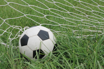 Fototapeta na wymiar Soccer ball in net