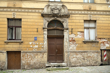 The arched door and windows of the old apartment building at the address: Peitavas street, 9/11. Riga, Latvia