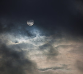 Fototapeta na wymiar Sun in dramatic dark clouds