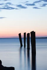 Acrylic prints Pier no pier only poles at sunset