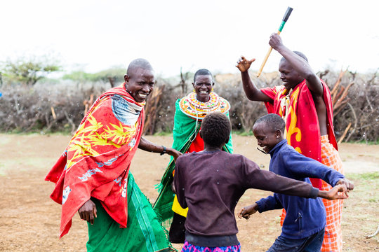 Massai family celebrating and dancing