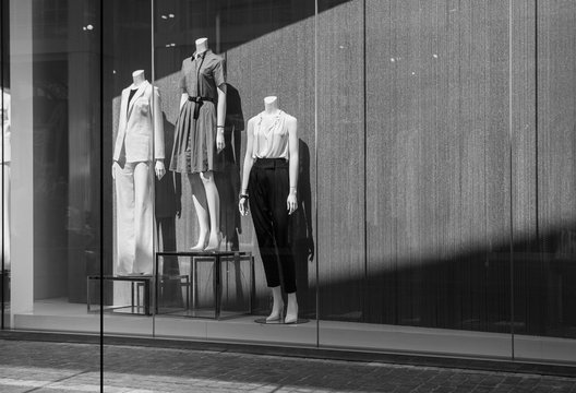 Female mannequins in a shop window. Black and white photo