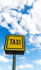 Taxi road sign on sky background
