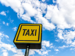 Taxi road sign on sky background
