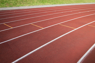 Athletic running track in modern red rubber close-up abstract background