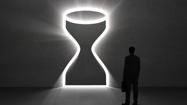 Businessman looking at giant egg timer