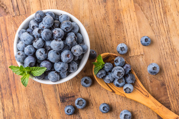 fresh blueberry on a wooden table and bowl