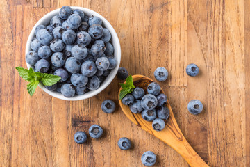 fresh blueberry on a wooden table and bowl