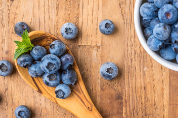 fresh blueberry on a wooden table and bowl