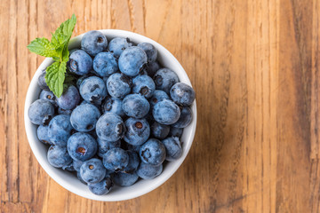 fresh blueberry on a wooden table and bowl