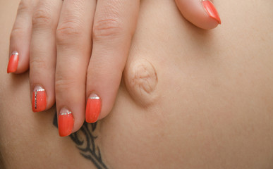 Pregnant woman caress her belly