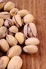 Pistachio nuts on wooden table, healthy eating