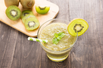 kiwi smoothie with fresh fruits on wooden table