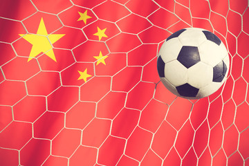 soccer ball on china flag vintage color