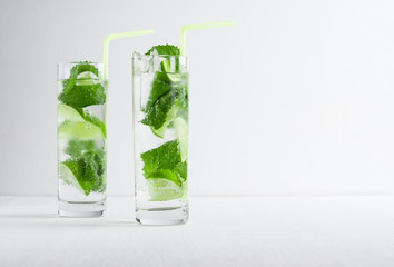 Mojito cocktail on the white wooden background