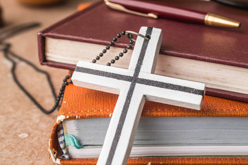 Cross against an old book.