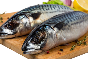 two fresh uncooked mackerel with lemon, onion, spices