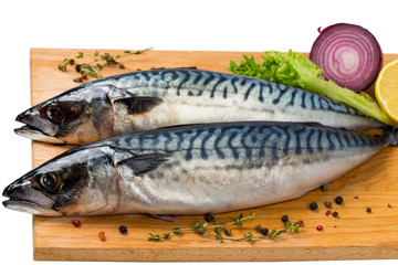 two fresh uncooked mackerel with lemon, onion, spices
