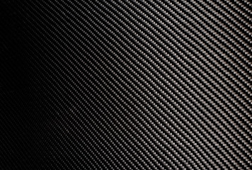 Woven carbon fiber sheet. Texture.