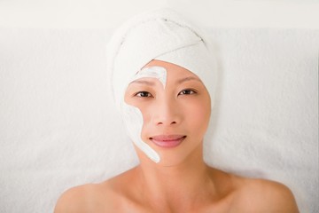 Attractive woman with cream treatment