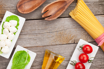 Tomatoes, mozzarella, pasta and green salad leaves