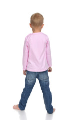 Rear view of caucasian baby boy kid in pink sweater and jeans